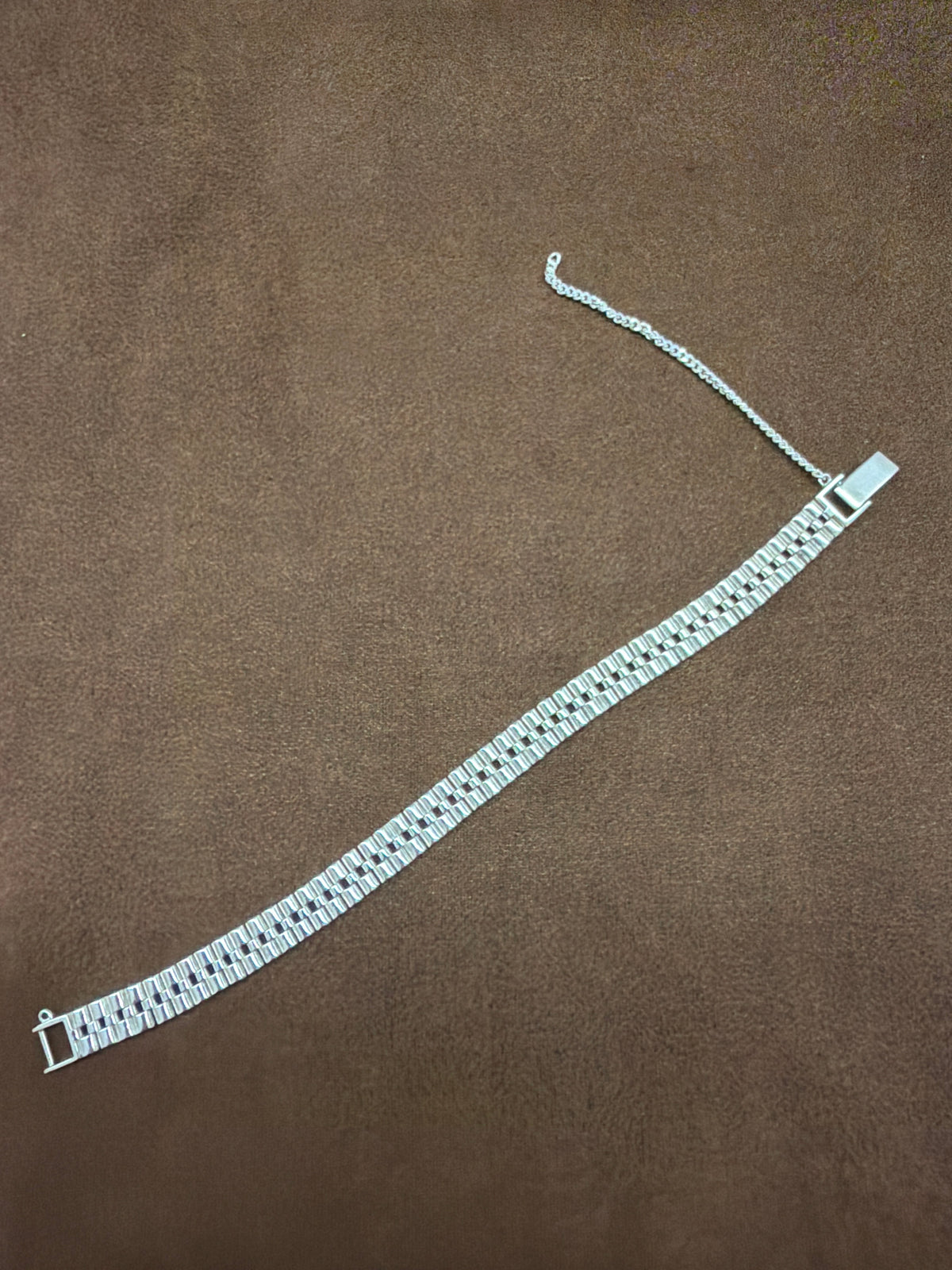 A55 925 sterling silver bracelet featuring multiple rows of textured rectangular links, rectangular clasp and safety chain.