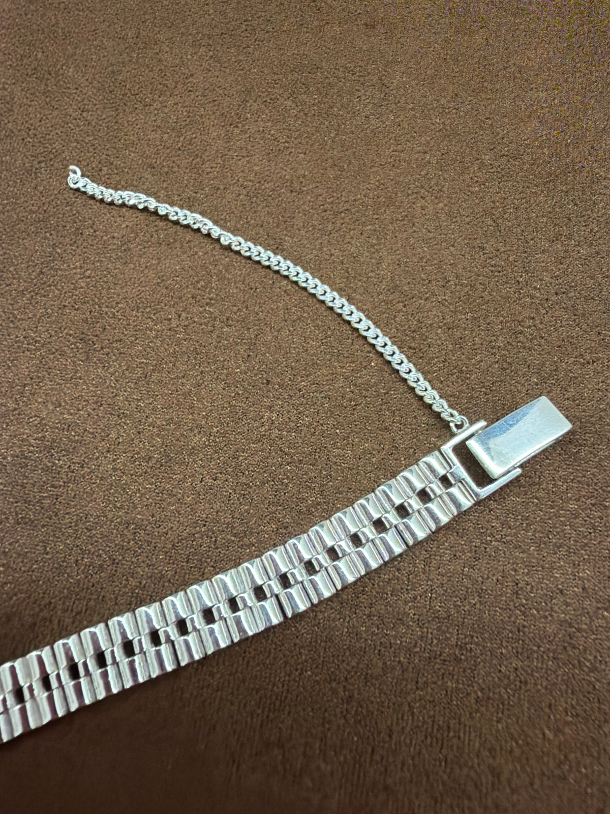 A55 925 sterling silver bracelet featuring multiple rows of textured rectangular links, rectangular clasp and safety chain.
