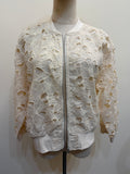H44 ivory floral openwork lace jacket on a mannequin, with a front zip, long sleeves and plain neckline, cuff and hem trims.
