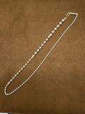A54 925 sterling silver necklace with graduated polished round beads, 44cm, photographed on brown fabric.