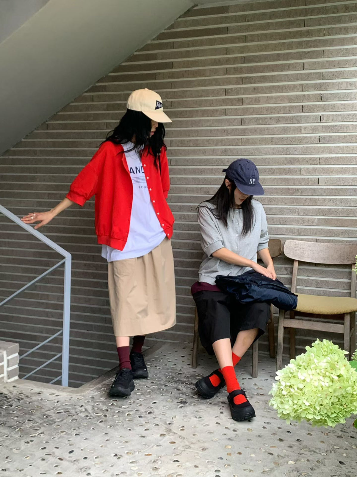 Two models wearing H62 jackets in red and gray, showing open-front and buttoned styling with relaxed half-length sleeves.
