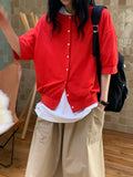 H62 red round-neck button-front jacket with dropped shoulders and half-length sleeves, layered over a white T-shirt with khaki wide-leg bottoms.