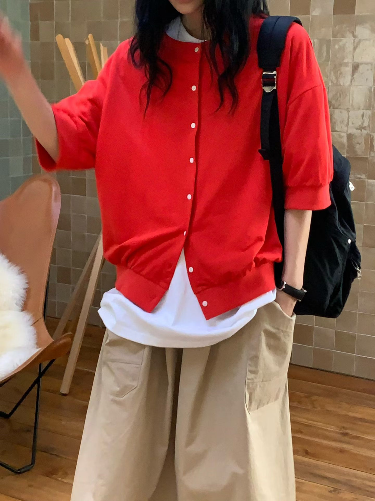 H62 red round-neck button-front jacket with dropped shoulders and half-length sleeves, layered over a white T-shirt with khaki wide-leg bottoms.