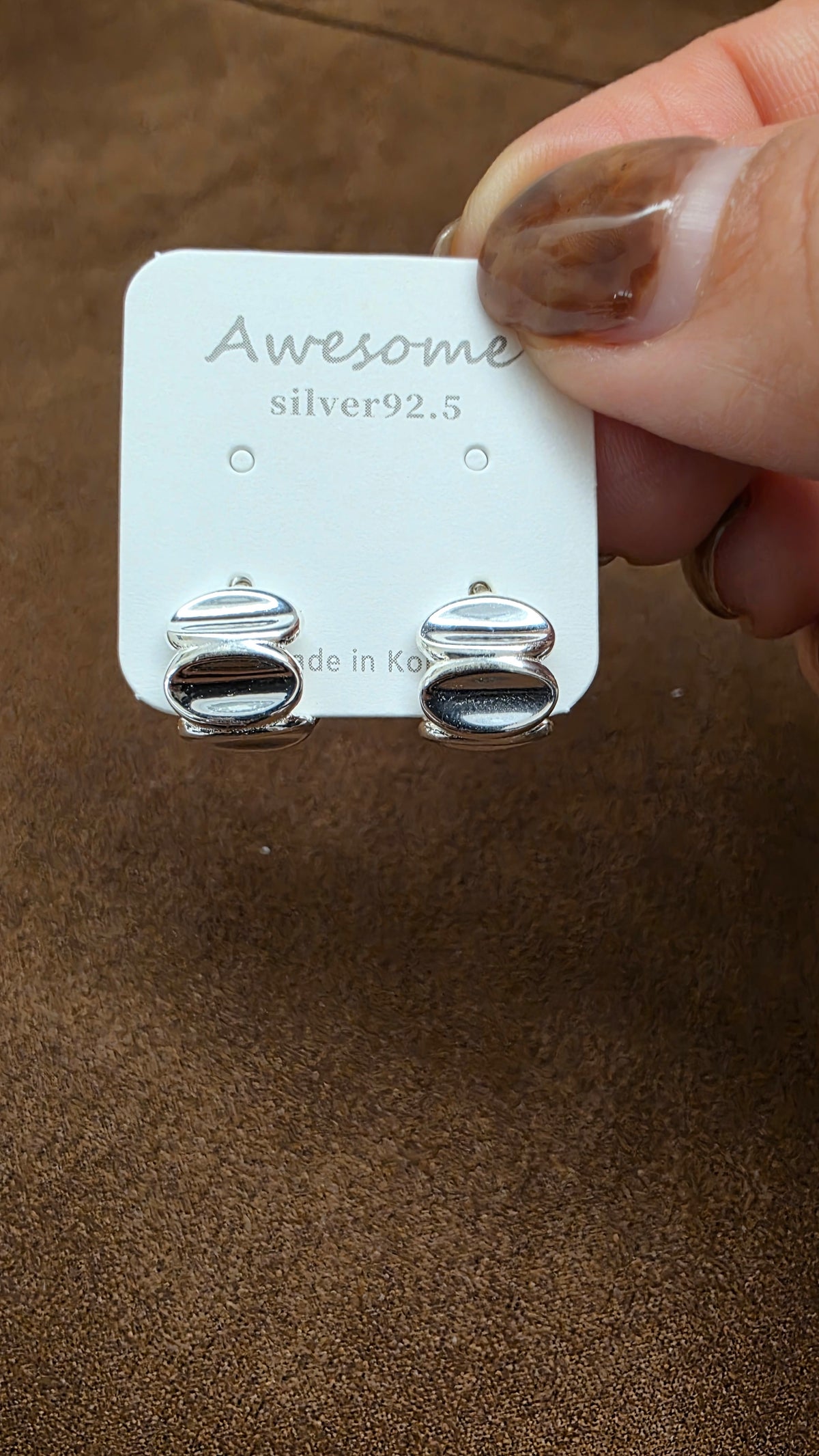 Front view of A66 silver-tone half-hoop earrings with stacked rounded oval faces on an Awesome silver92.5 display card.