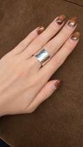 A57 wide silver-tone ring with irregular hammered texture worn on a hand, Korean ring size 14.